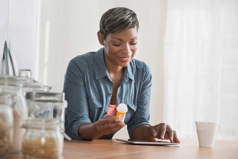 woman researching her prescription on tablet