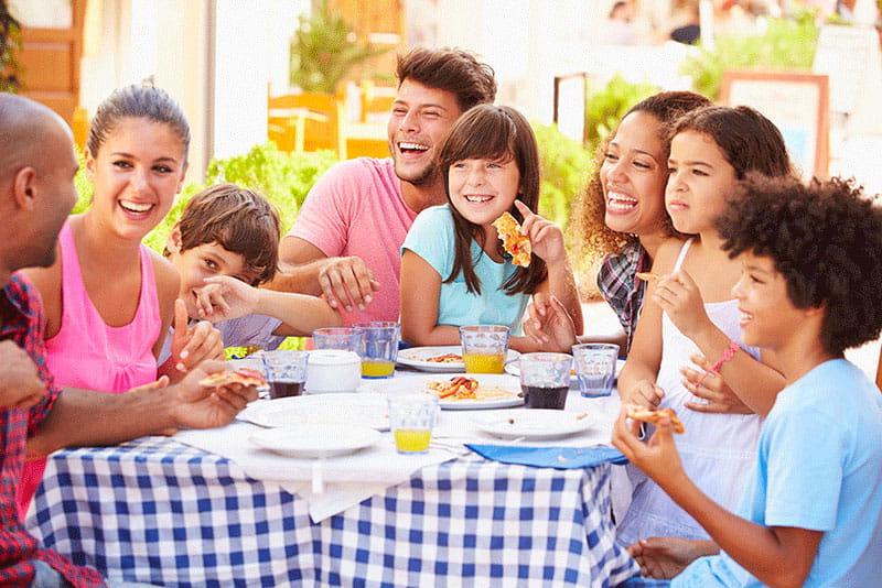 multi-ethic family eating meal at home